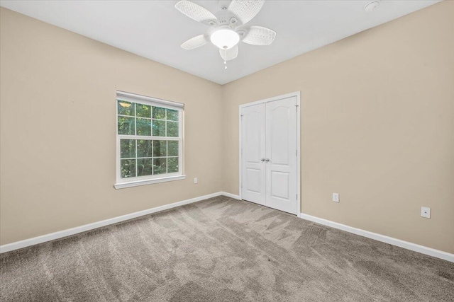 unfurnished bedroom with carpet, ceiling fan, and a closet