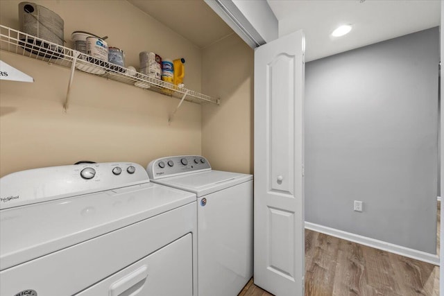 laundry area featuring light hardwood / wood-style flooring and washer and dryer