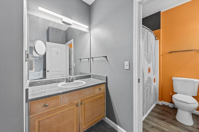 bathroom featuring hardwood / wood-style flooring, vanity, toilet, and a shower with shower curtain