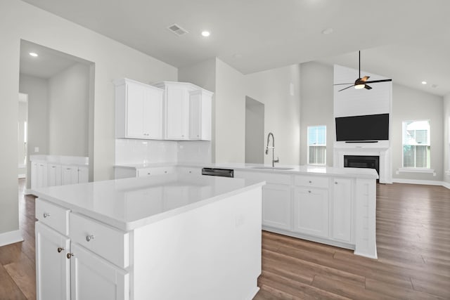 kitchen with a kitchen island, white cabinetry, and sink