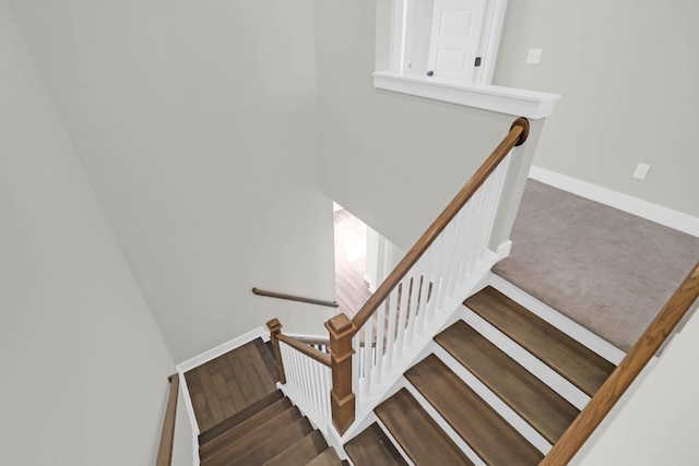 staircase with hardwood / wood-style flooring