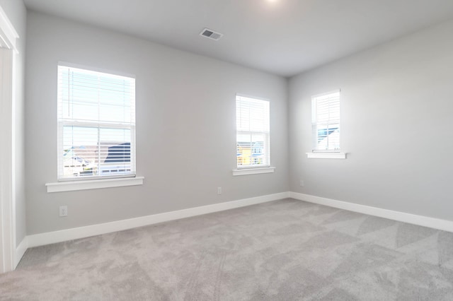 unfurnished room with light colored carpet