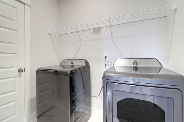 laundry area with independent washer and dryer