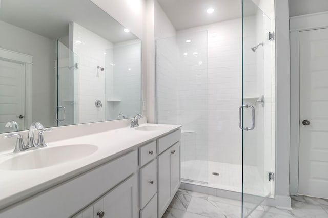 bathroom featuring vanity and a shower with door