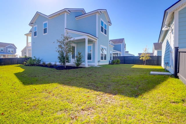 back of house with a yard