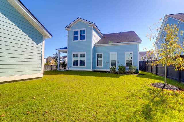 rear view of house with a yard