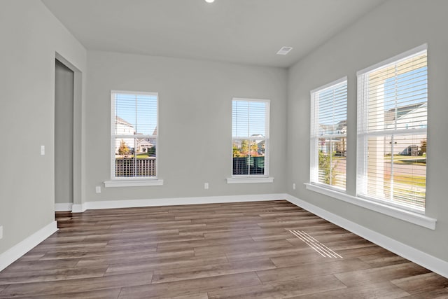 unfurnished room featuring hardwood / wood-style flooring