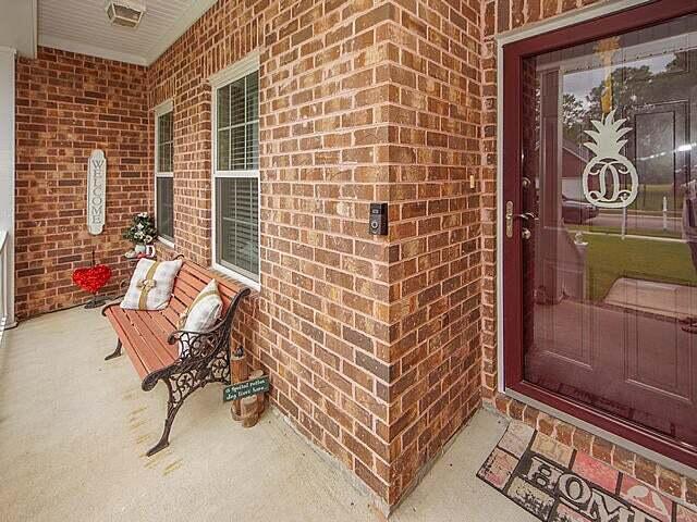 view of exterior entry with covered porch