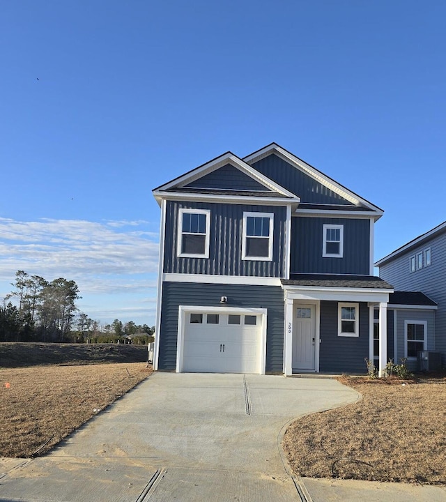 view of front of home featuring driveway, board and batten siding, a garage, and central AC