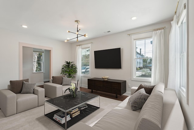 living room with an inviting chandelier and plenty of natural light