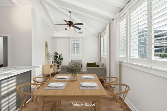 dining room with lofted ceiling with beams, ceiling fan, and a healthy amount of sunlight