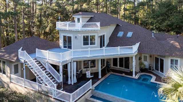 back of house featuring a balcony and a patio