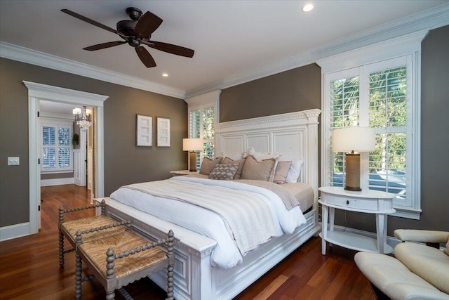 bedroom with dark hardwood / wood-style flooring, ceiling fan, and ornamental molding