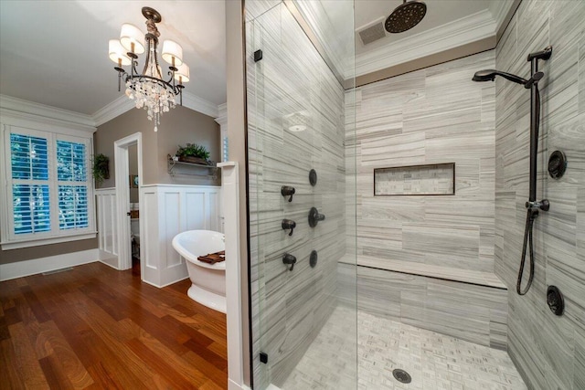 bathroom with crown molding, plus walk in shower, wood-type flooring, and an inviting chandelier