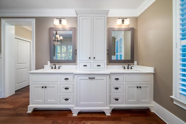 bathroom featuring crown molding, vanity, a notable chandelier, and hardwood / wood-style flooring