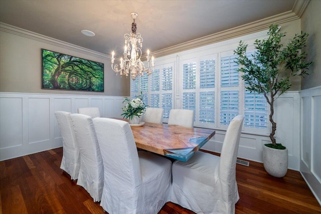 dining space featuring crown molding, a chandelier, and dark hardwood / wood-style floors