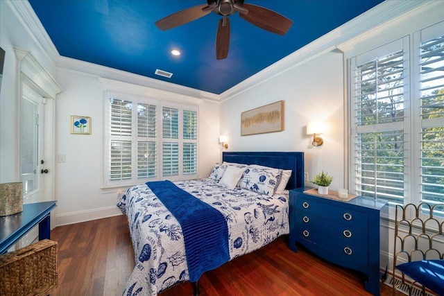 bedroom with ceiling fan, dark hardwood / wood-style floors, ornamental molding, and multiple windows