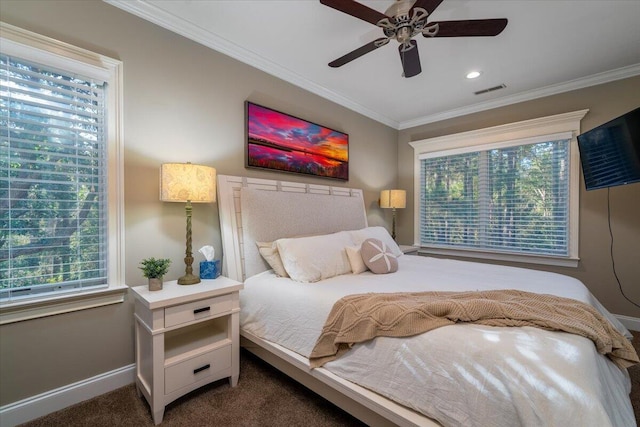 bedroom featuring ceiling fan, crown molding, and dark colored carpet