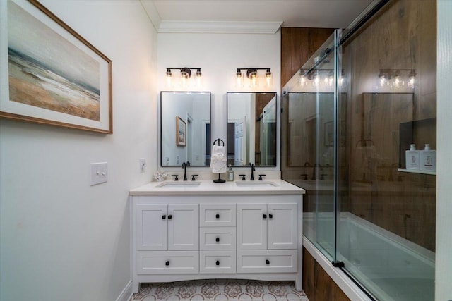 bathroom featuring vanity, combined bath / shower with glass door, and ornamental molding