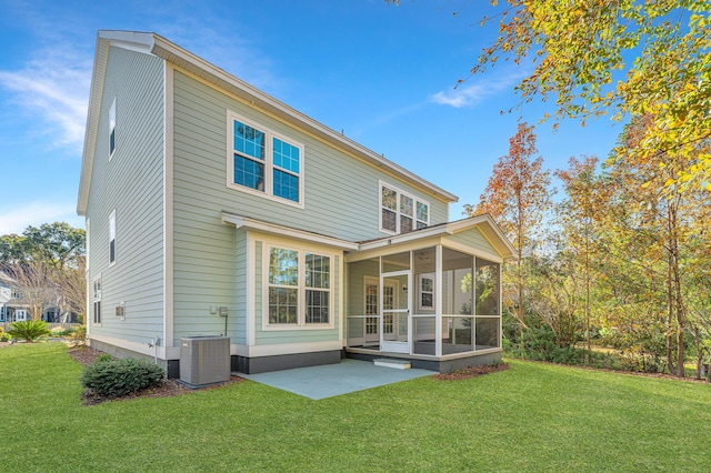 rear view of property with cooling unit, a lawn, a sunroom, and a patio