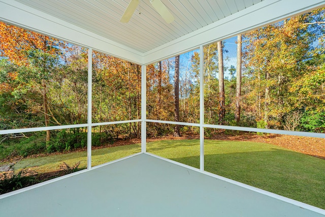 unfurnished sunroom with ceiling fan