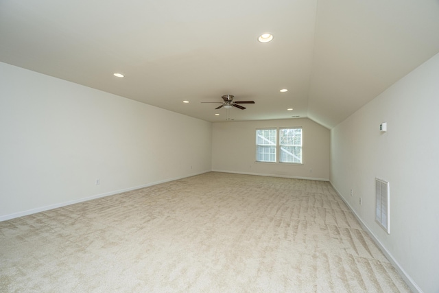 carpeted empty room featuring lofted ceiling and ceiling fan