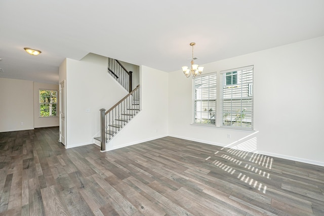 interior space featuring plenty of natural light, dark hardwood / wood-style floors, and a chandelier