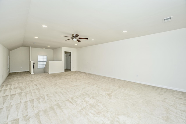 interior space with lofted ceiling, light colored carpet, and ceiling fan