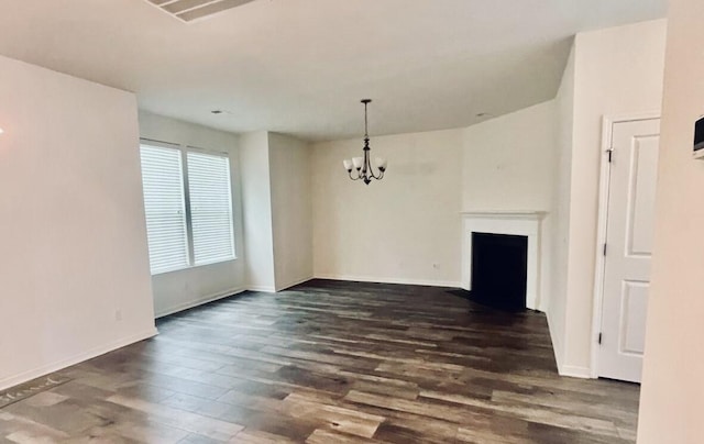 unfurnished dining area with dark hardwood / wood-style floors and a chandelier