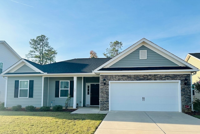 view of front of property with a garage and a front lawn