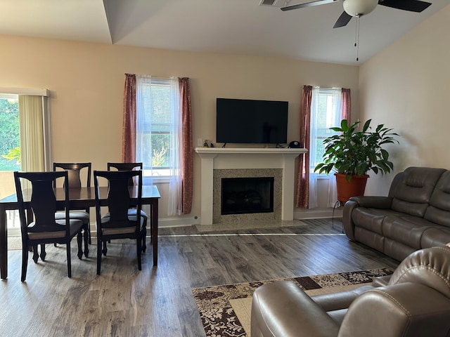 living room with hardwood / wood-style floors, a healthy amount of sunlight, ceiling fan, and vaulted ceiling