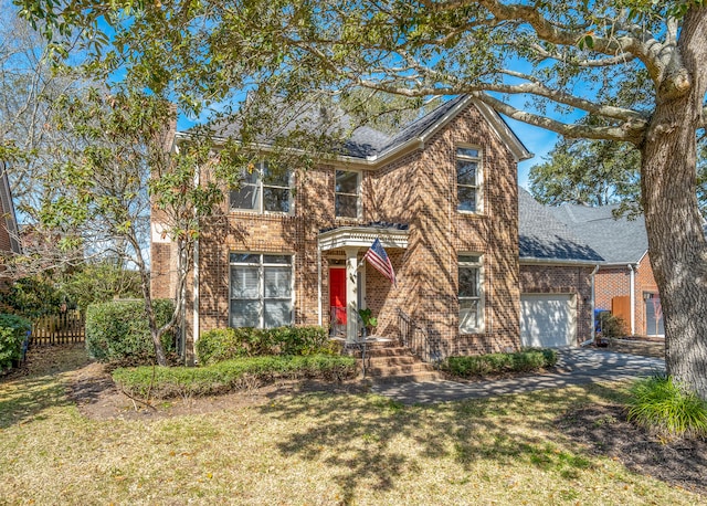 view of front of property with a front lawn and a garage