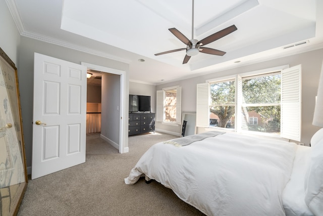 bedroom featuring crown molding, ceiling fan, light colored carpet, and a raised ceiling