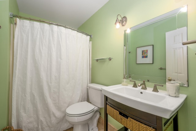 bathroom featuring toilet, vanity, tile patterned floors, and a shower with shower curtain