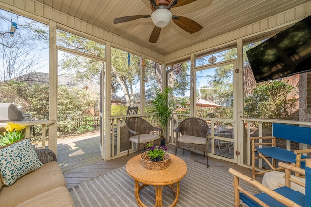 sunroom / solarium with wood ceiling, ceiling fan, and a wealth of natural light