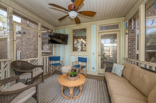 sunroom with wood ceiling and ceiling fan