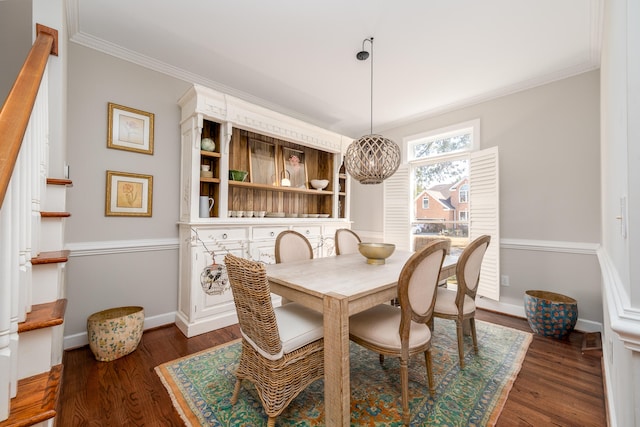 dining area with ornamental molding and dark wood-type flooring