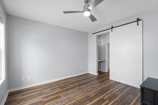 130 River Landing Dr Unit 4102, Charleston, SC 29492 - unfurnished bedroom featuring a barn door, dark wood-style floors, baseboards, and ceiling fan
