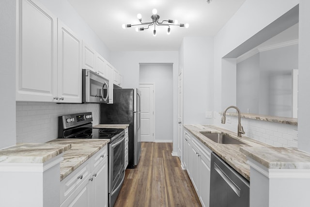 130 River Landing Dr Unit 4102, Charleston, SC 29492 - kitchen featuring appliances with stainless steel finishes, a sink, tasteful backsplash, light stone counters, and white cabinets