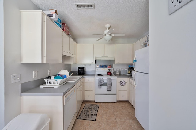 kitchen featuring a textured ceiling, ceiling fan, and white appliances