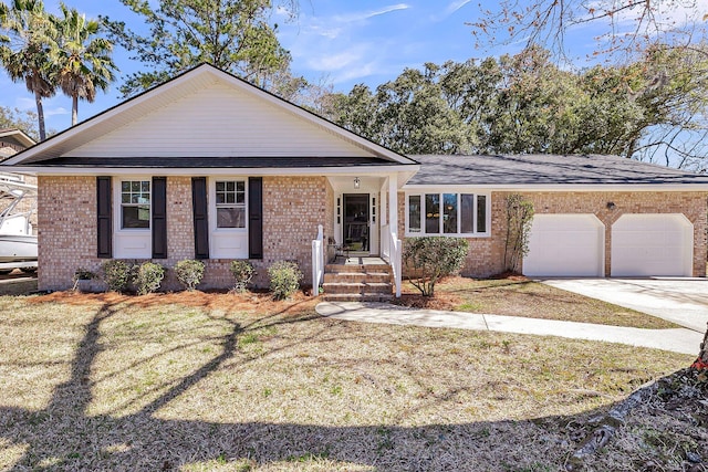 view of front of property with a garage, a front lawn, brick siding, and driveway