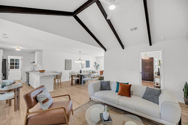 living area with a chandelier, visible vents, vaulted ceiling with beams, and light wood-type flooring