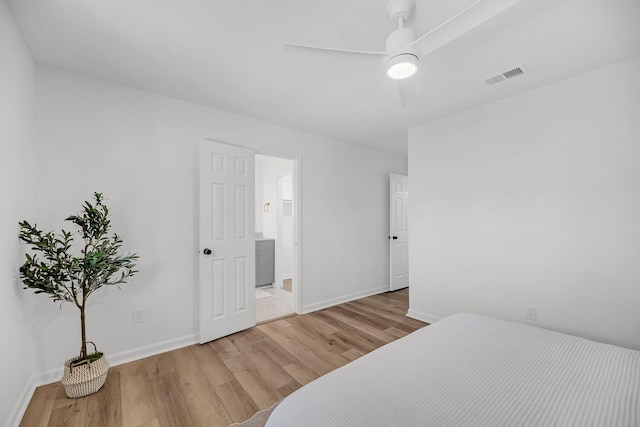 bedroom with visible vents, baseboards, light wood-style flooring, and a ceiling fan