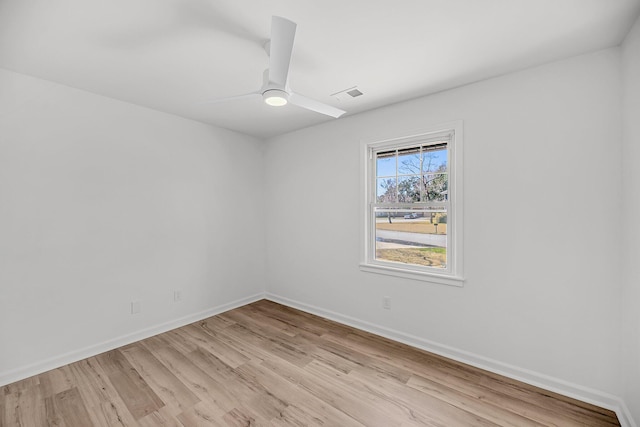 empty room with visible vents, baseboards, light wood-style floors, and ceiling fan