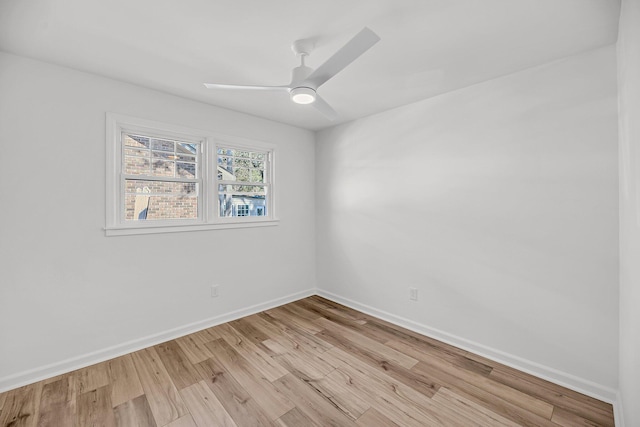 unfurnished room with baseboards, light wood-style floors, and a ceiling fan