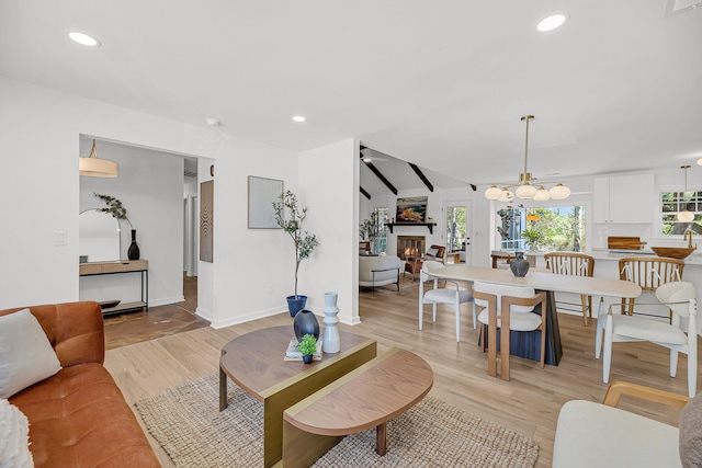 living room with a wealth of natural light, a glass covered fireplace, and recessed lighting