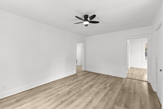 spare room featuring ceiling fan, light hardwood / wood-style flooring, and a textured ceiling