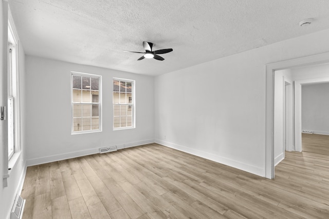 unfurnished room featuring ceiling fan, a textured ceiling, and light hardwood / wood-style floors