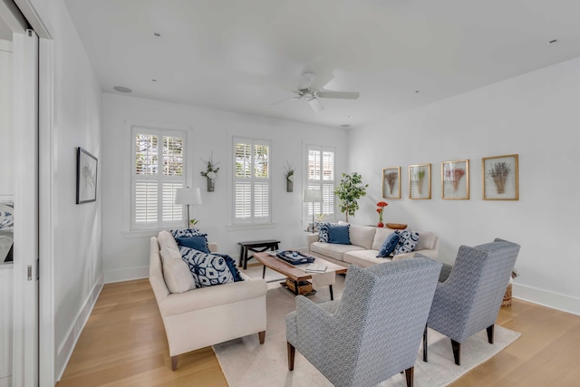 living room featuring ceiling fan and light hardwood / wood-style flooring