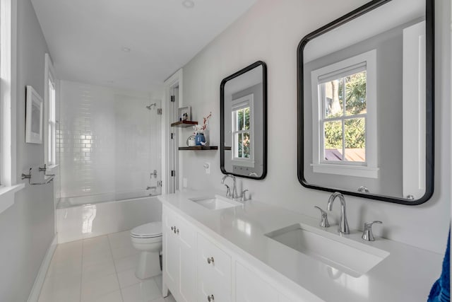 full bathroom with toilet, tiled shower / bath combo, tile patterned flooring, and vanity